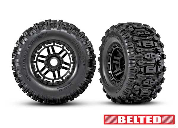 Traxxas Tires & wheels, assembled, glued (black wheels, belted Sledgehammer® All-Terrain tires, dual profile (2.9" outer, 3.8" inner), foam inserts) (2) (17mm splined) (TSM® rated)